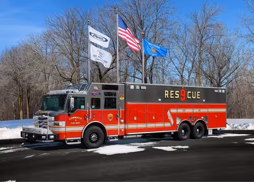 Heavy rescue truck front-left exterior view showing cab and tandem rear section