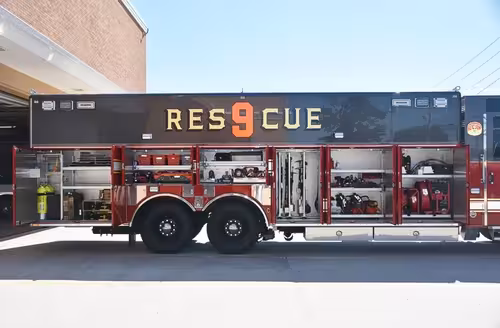 Heavy rescue truck side profile view showing open compartments and large unit lettering