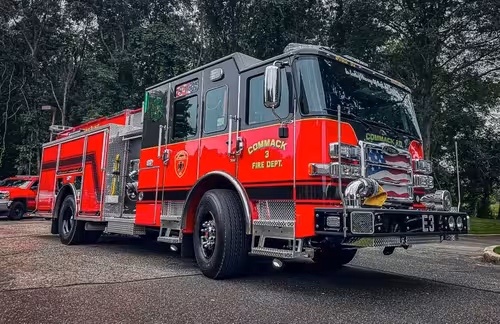 Pumper rear-left exterior view showing side body and rear warning lights