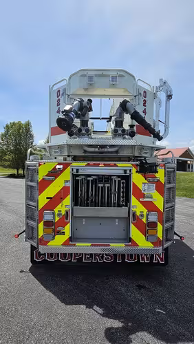 Rear view showing bucket platform and chevron-striped rear panel