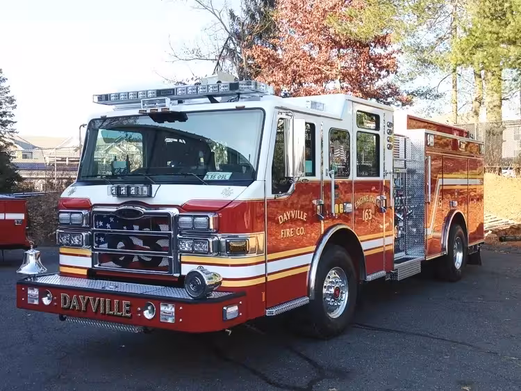 Pumper front-left exterior view showing enclosed cab and side compartments
