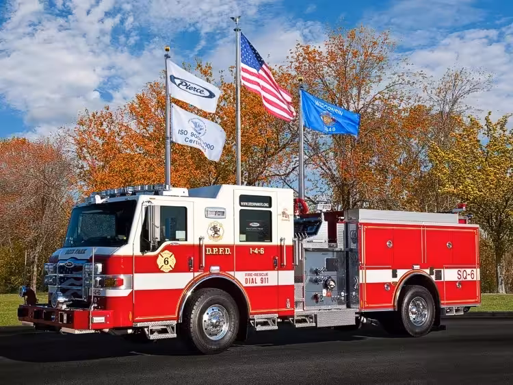 Pierce custom pumper front-left exterior view with enclosed cab and side compartments