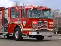 Pumper front-left exterior view showing enclosed cab and side compartments