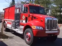 Tanker front-left exterior view showing commercial-style cab and long tank body