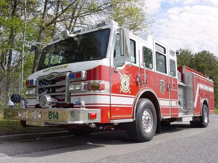 Pumper front-left exterior view showing enclosed cab and side compartments