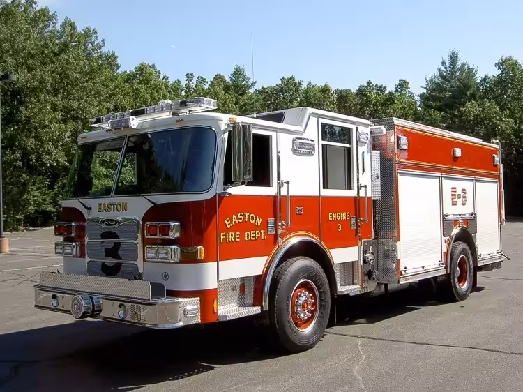Pumper front-left exterior view showing enclosed cab and side compartments
