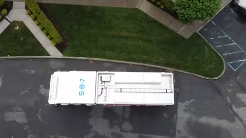 Aerial top-down side view showing full apparatus length and compartments