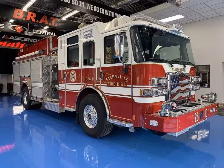 Pumper front-left exterior view showing grille, bumper, and cab