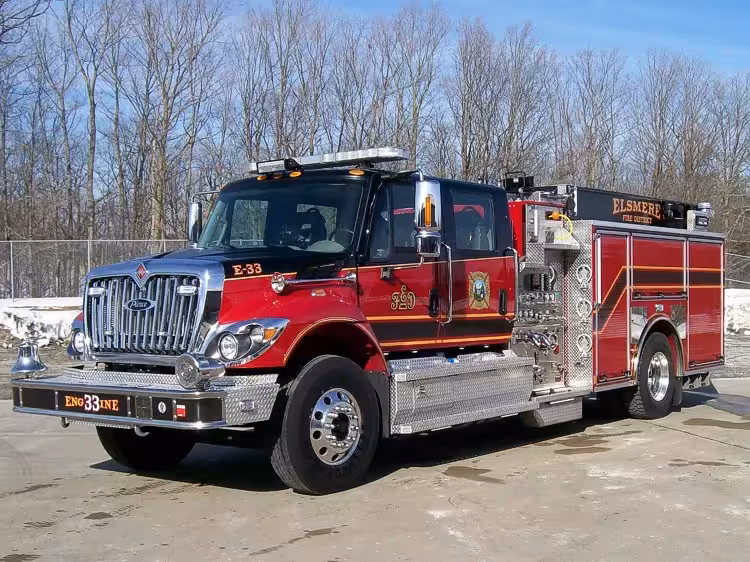 Pumper front-left exterior view showing grille, bumper, and side compartments