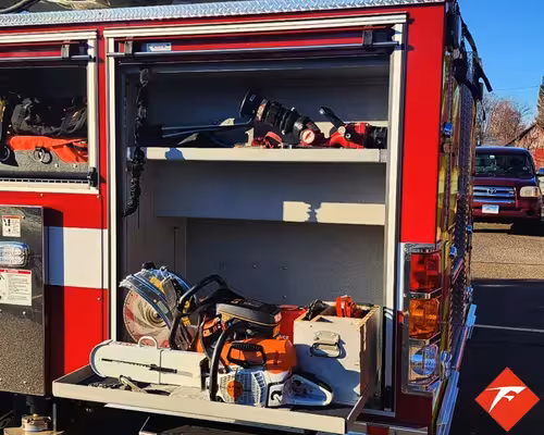 Open side compartment showing shelves with gear and equipment bags