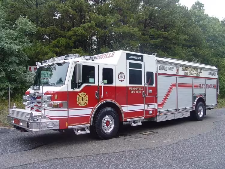Front left exterior view of the heavy rescue with command cab, chrome bumper, and side roll-up compartments.