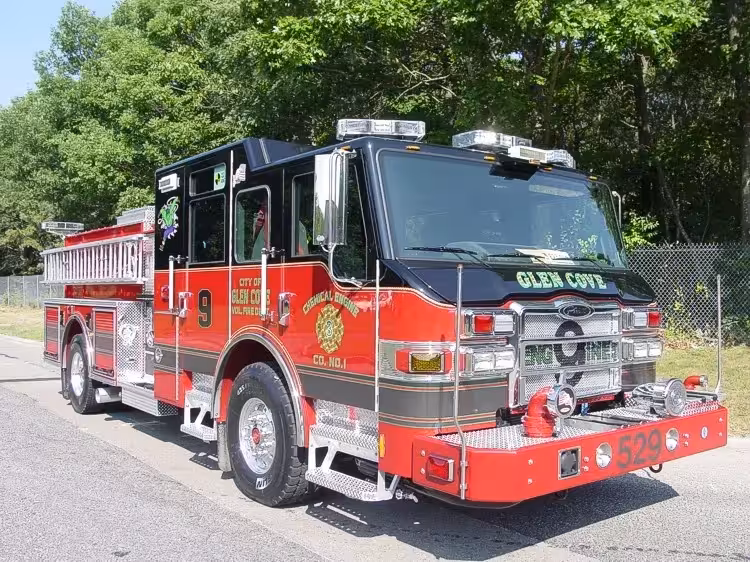 Front-right exterior view of an engine showing the cab, bumper, side compartments, and rear wheel area.