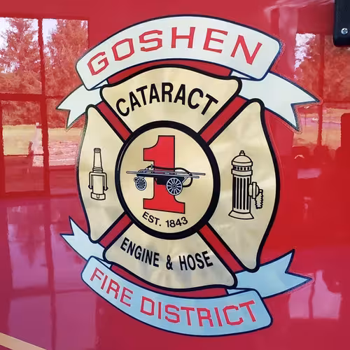 Cab door close-up showing circular department crest on red panel