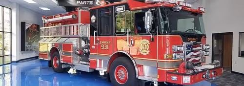 Pumper front-left exterior view parked inside apparatus bay
