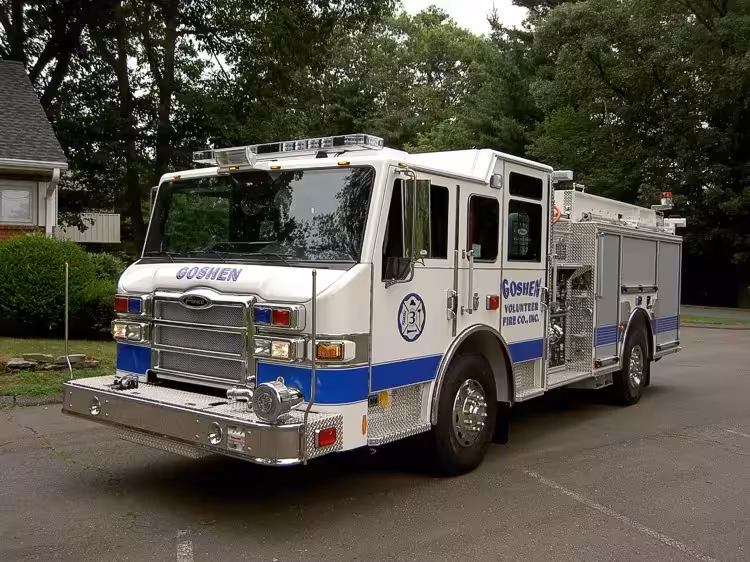 Pumper front-left exterior view showing enclosed cab and side compartments