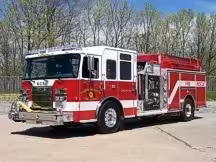 Pumper front-left exterior view showing enclosed cab and side compartments