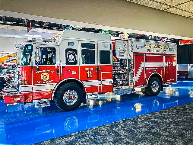 Pumper front-left exterior view showing grille, bumper, and side compartments