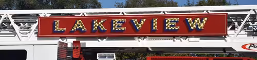 Close-up of large ladder-side logo panel with gold lettering