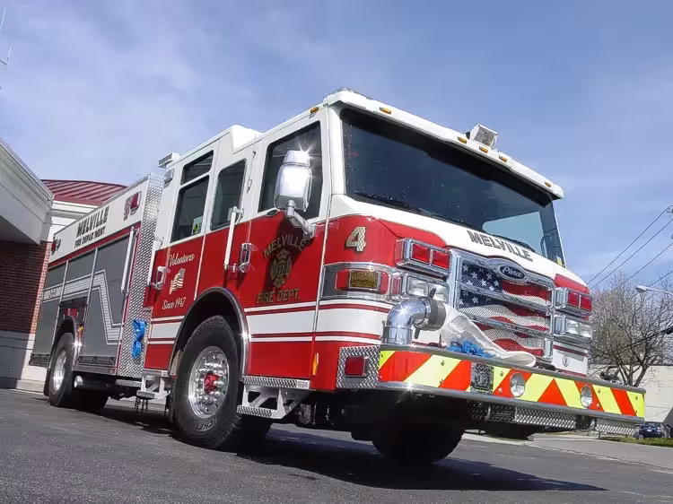 Low front-left exterior view showing bumper, cab, and side compartments