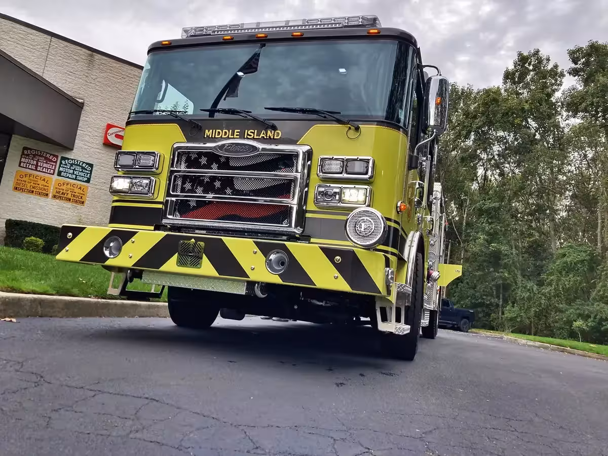Pumper front-right exterior view showing cab, bumper, and side compartments