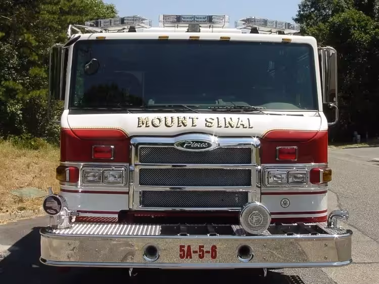 Front exterior view showing grille, bumper, and warning lights
