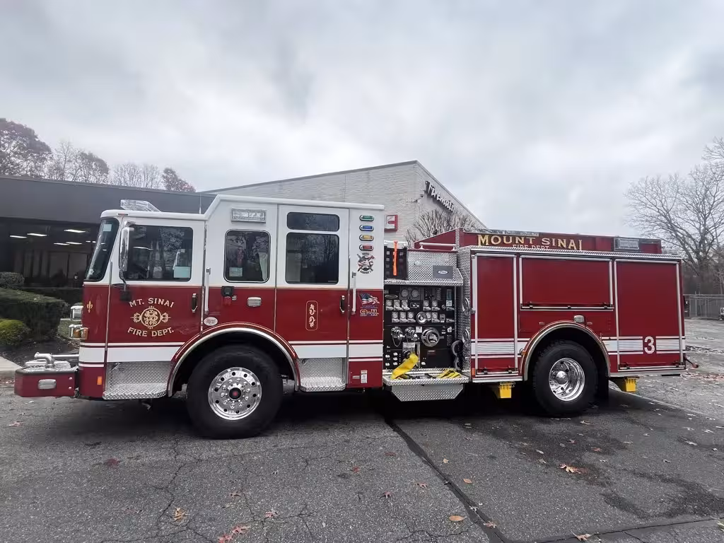 Pumper driver-side profile view showing side compartments and wheel area
