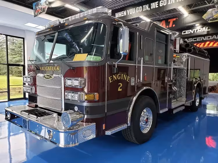 Pumper front-left exterior view showing dark cab top and side body