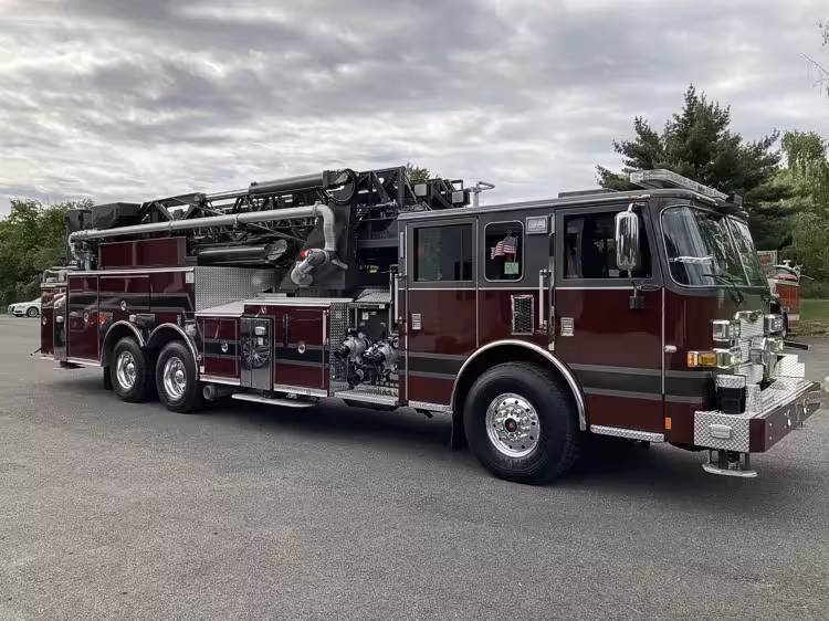 Tower ladder truck front-left exterior view showing long ladder body