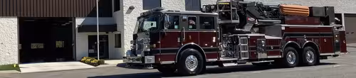 Driver-side profile strip view showing full ladder truck body