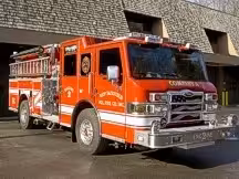 Front-left exterior view showing cab, bumper, and side compartments