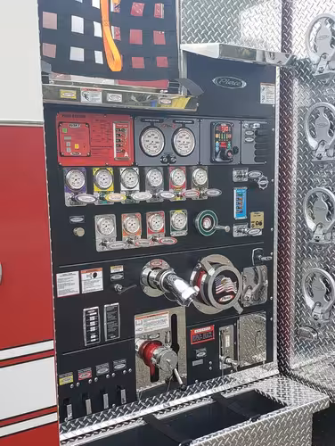 Pump panel close-up showing gauges, valves, and intake controls