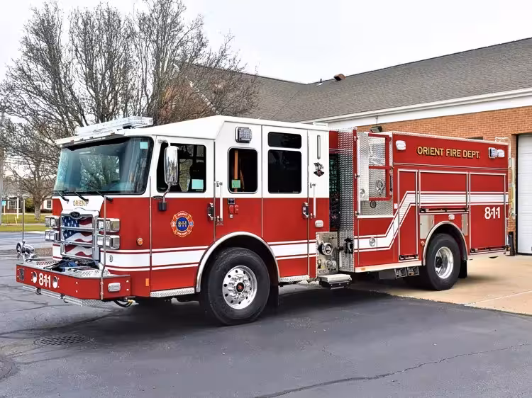 Pumper front-left exterior view showing grille, bumper, and crew cab