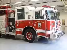 Wide front-right thumbnail view of the squad pumper parked inside the station.