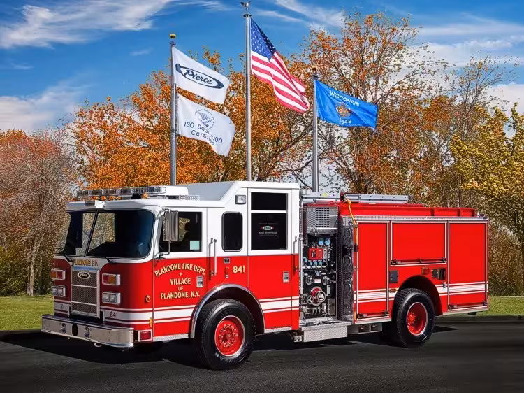 Pierce Saber pumper front-left exterior view with pump panel and enclosed cab