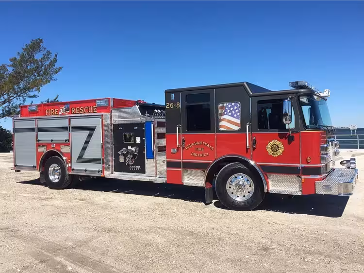 Rescue pumper side profile view showing enclosed cab and side compartments