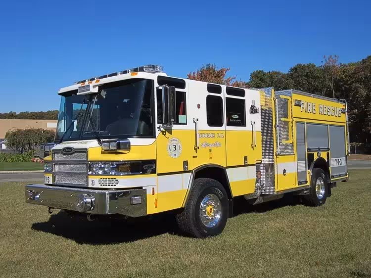 Heavy rescue truck front-left exterior view showing enclosed cab and long body