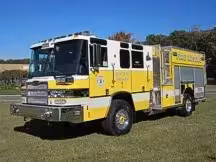 Front-left exterior view showing long body and side compartment layout