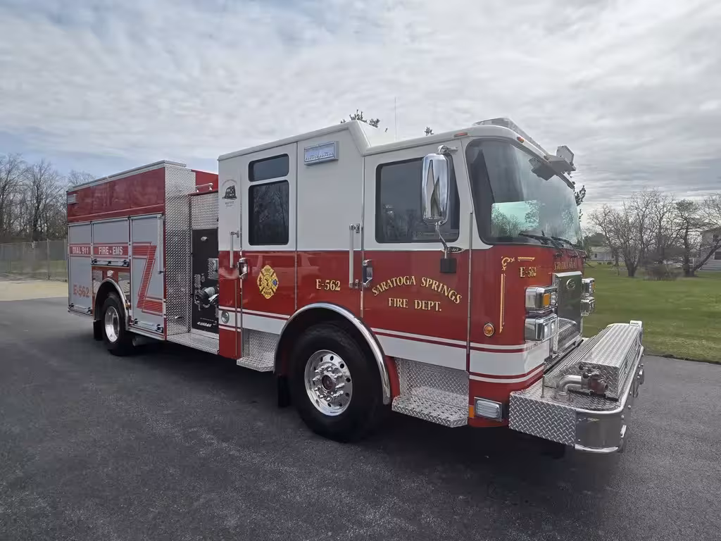 Pumper front-right exterior view showing enclosed cab, side compartments, and front bumper intake