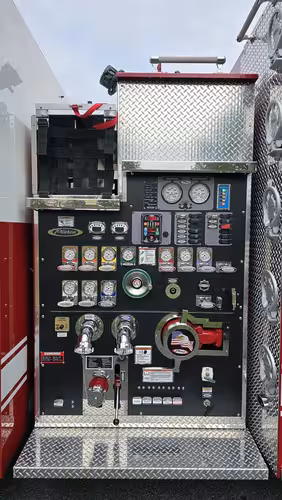 Pump panel close-up showing gauges, valves, intake ports, and control switches