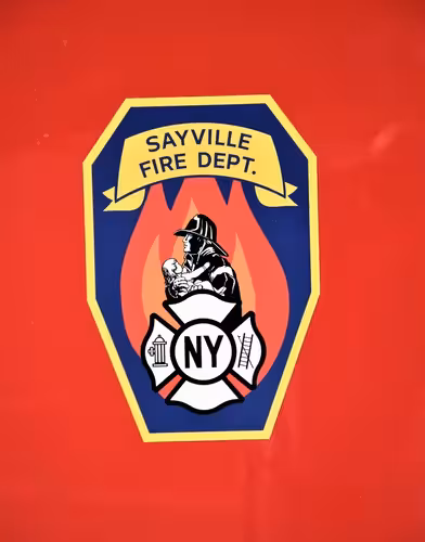 Body emblem close-up showing a shield-style department logo on red paint