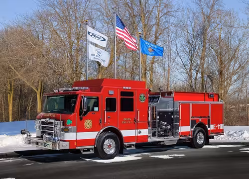 Front-left profile of another matching pumper with side pump panel area and rear compartments visible.