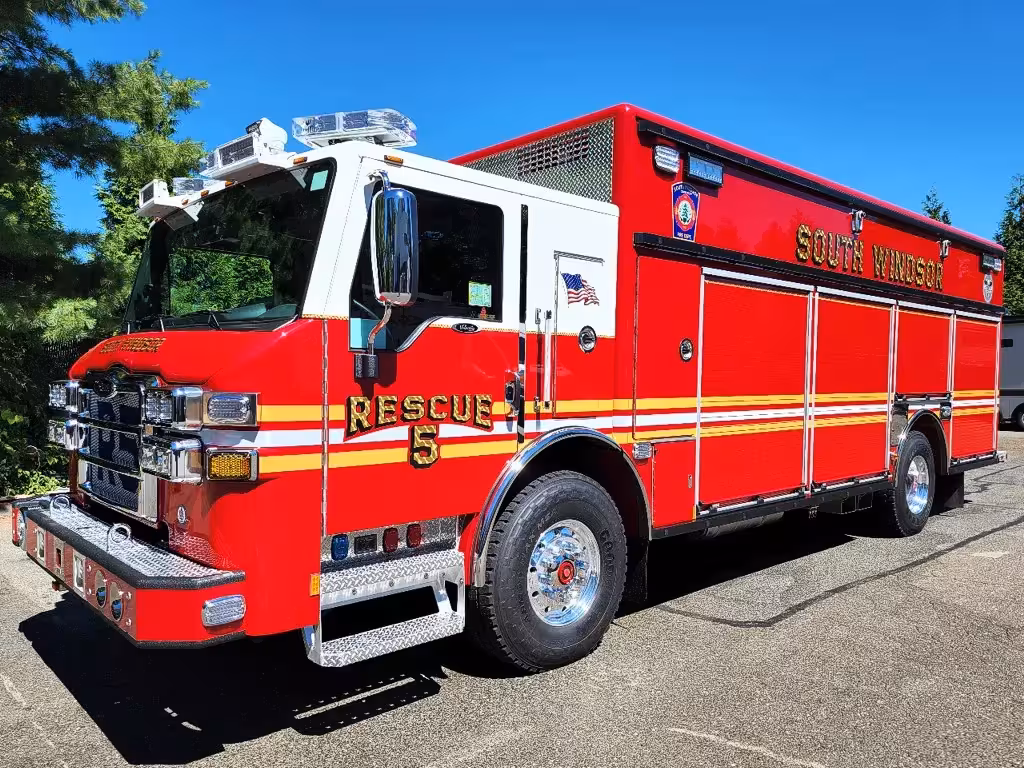 Heavy rescue truck front-left exterior view showing enclosed cab and side body