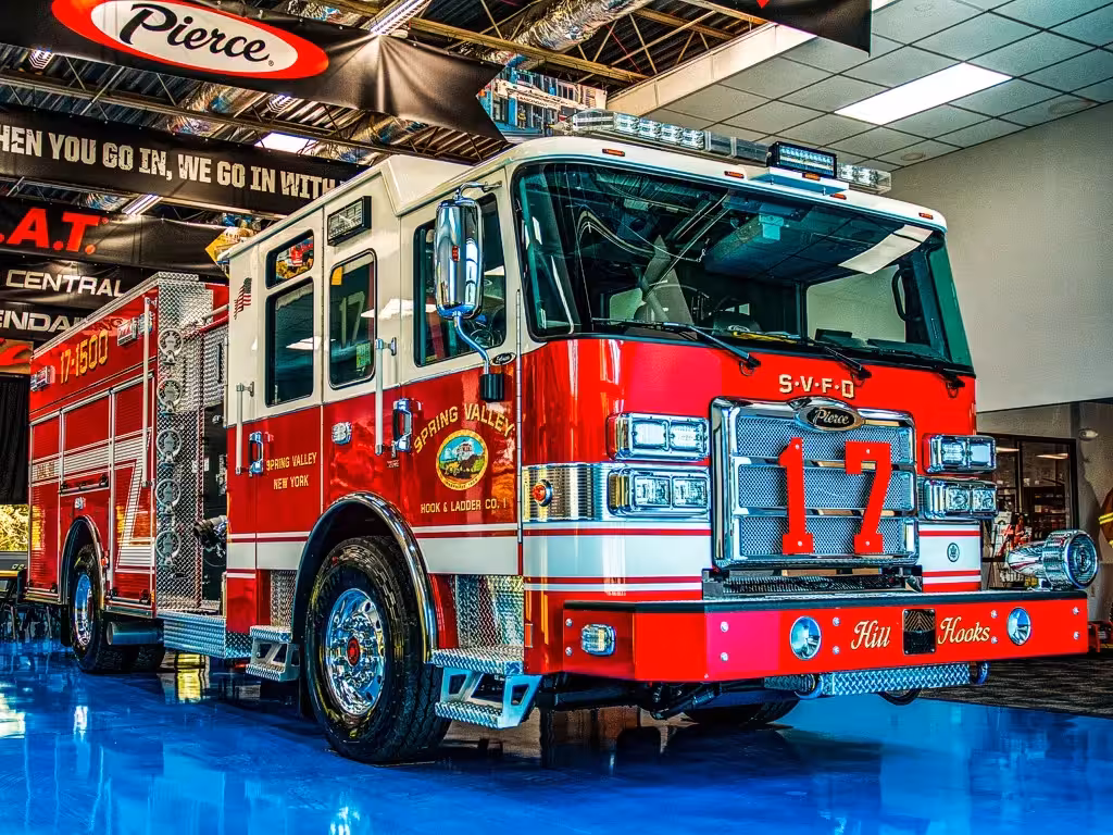 Pumper front-left exterior view indoors showing bumper, cab, and side compartments