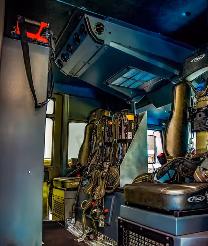 Cab interior rear crew area showing seats, seat mounts, and center aisle