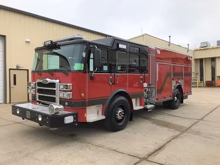 Pierce Arrow PUC pumper front-left exterior view showing enclosed cab and side compartments