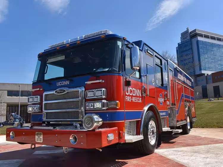 Pumper front-left exterior view showing grille, bumper, and enclosed cab