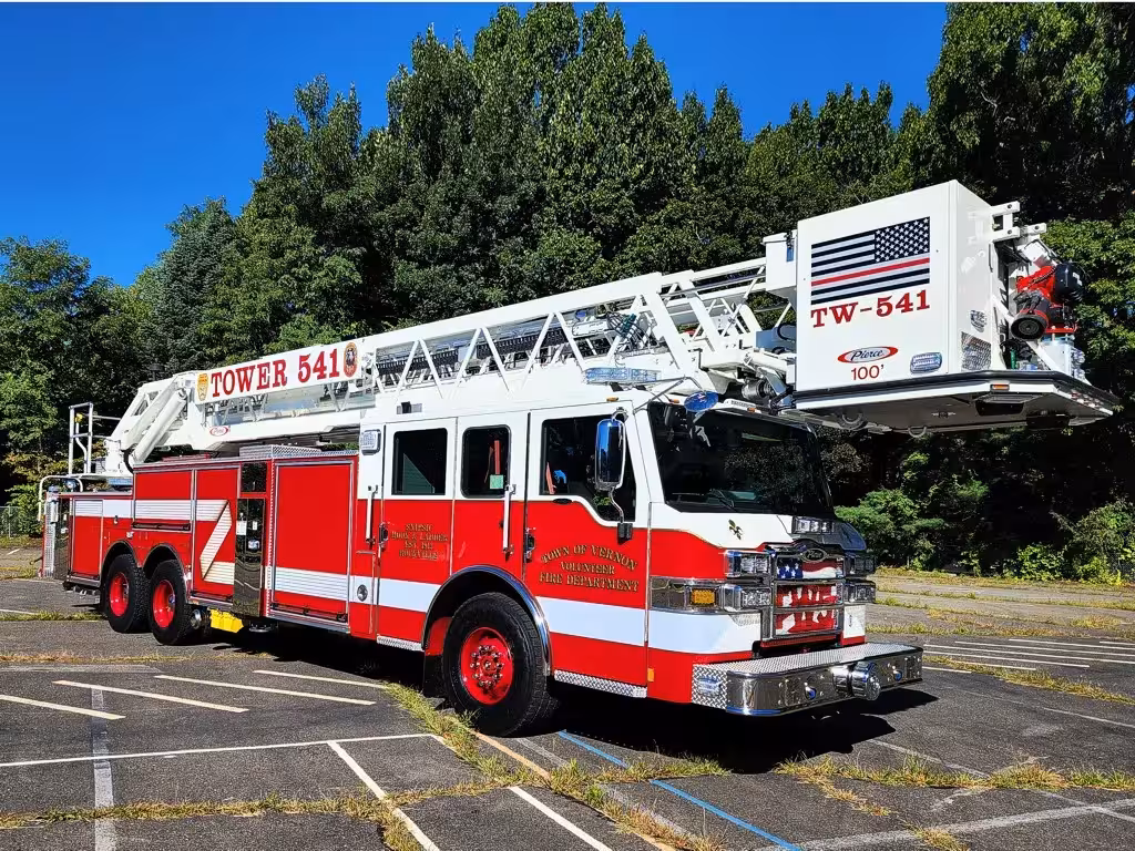 Tower ladder truck front-left exterior view showing aerial sections and cab