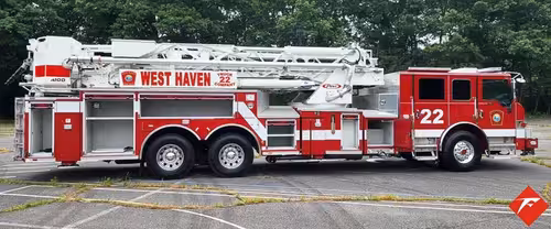Driver-side full profile showing tower ladder body and tandem wheels