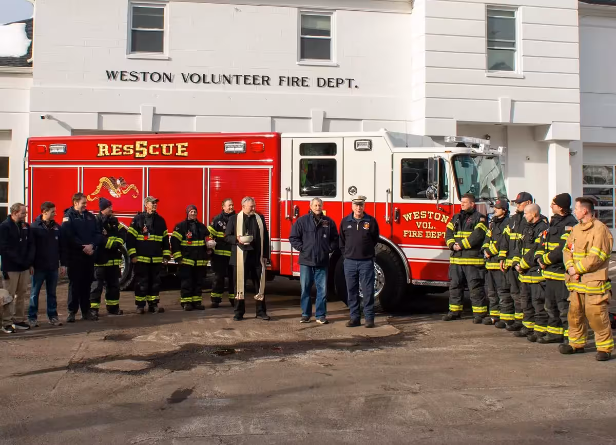 Weston Pierce heavy rescue group photo in front of the station with firefighters posed beside the truck