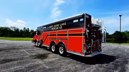 Driver-side profile view showing long rescue body and side compartments